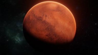 在<strong>火星</strong>上的红色行星在恒星和星云背景上围绕着太空的轴线旋转。照得<strong>火星</strong>变焦了现实主义3D艺术4k可视化